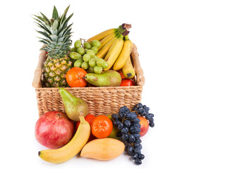 Mix variety of fresh juicy colorful exotic tropical fruits in basket on white background