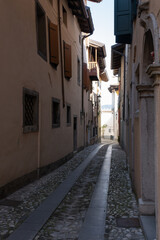 Cividale del Friuli (Udine), Italy - September 5, 2021: North Italy Life in the center of the lombard medieval city. Walking through narrow streets and walls. Sunny summer day. Selective focus