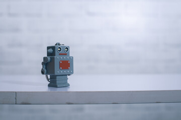 Retro robot toy on desk with background