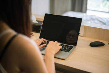 Back view of woman talk with partner using video call on laptop.