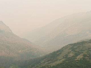 Naklejka premium Rolling mountain hills create layers of depth in a Rocky Mountain landscape image.
