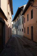Fototapeta na wymiar Cividale del Friuli (Udine), Italy - September 5, 2021: North Italy Life in the center of the lombard medieval city. Walking through narrow streets and walls. No people. Sunny day. Selective focus