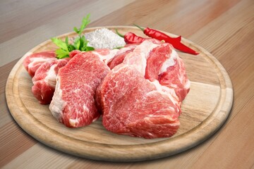 Raw red fresh steak of beef on a board with seasonings