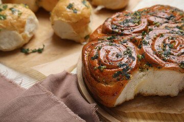 Traditional Ukrainian bread (Pampushky) with garlic on white wooden table, space for text