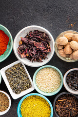 spices and herbs for cooking. Sumac, pepper, paprika, rosemary, khmelisuneli, cloves and more fresh portion ready to eat meal snack on the table copy space food background rustic. top view