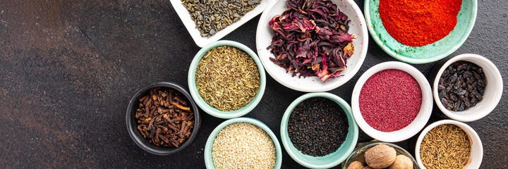 spices and herbs for cooking. Sumac, pepper, paprika, rosemary, khmelisuneli, cloves and more fresh portion ready to eat meal snack on the table copy space food background rustic. top view