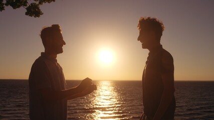 Gay couple engagement at seaside, man in love making proposal to boyfriend