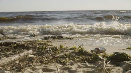 Garbage washed by sea water on beach, environmental contamination problem nature