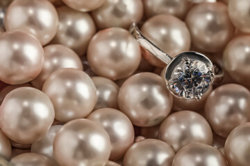 Beautiful decor pearls and engagement ring, closeup. Space for text
