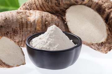 Fototapeta na wymiar Taro Root of Colocasia esculenta and Organic Taro Flour in a bowl
