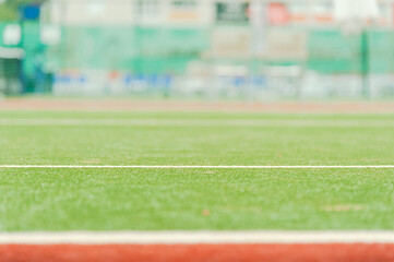 Tennis court as backdrop, soft focus photo.