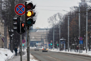 traffic light on a defocused city background on a winter day