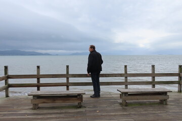 Fototapeta na wymiar man sitting on a pier