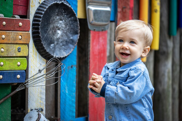 Obraz na płótnie Canvas Little blond haired boy playing on the playground