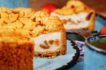 Closeup homemade pie with nectarines on wooden table. Shallow focus.