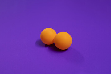 Pop art isolated image of two yellow table tennis balls with purple background. It can be used as an illustration or sporting image.