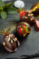 Fresh chocolate covered strawberries on a gray decorative background. Concept for advertising the summer seasonal menu