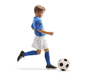Full length profile shot of a boy running with soccer ball