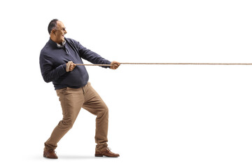 Full length profile shot of a mature man pulling a rope