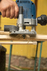 Processing the edge of the board with a milling machine.