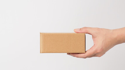 Back of the hand.Hand is holding brown box isolated on white background.