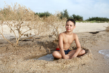 Child resting on beach of Azov sea