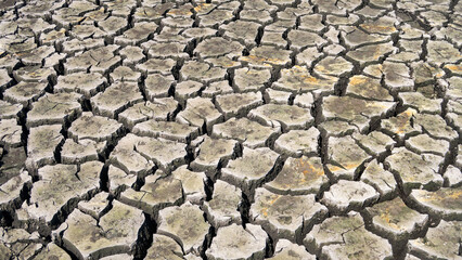 Cracked earth in a severe drought. The unbearable heat.