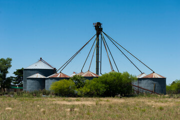 round sheet metal grain silos in the field