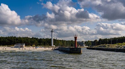 view of the lighthouse and harbor entrance in Leba