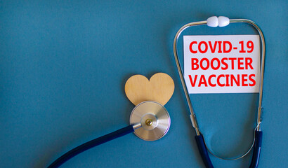 Covid-19 booster shots vaccines symbol. White card with words Covid-19 booster vaccines, beautiful blue background, wooden heart and stethoscope. Covid-19 booster shots vaccines concept. - obrazy, fototapety, plakaty