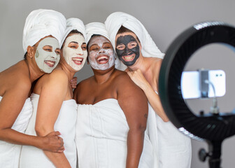 Diverse women taking selfie during spa session