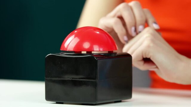 The woman presses the red button. Stop.