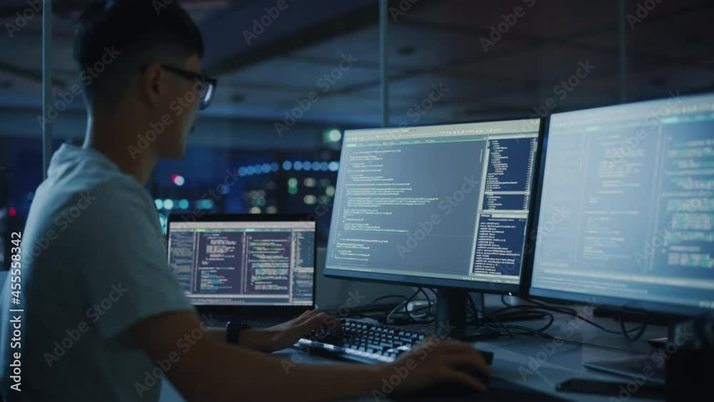 Poster Night Office: Young Japanese Man in Working on Desktop Computer. Digital Entrepreneur Typing Code, Creating Modern Software, e-Commerce App Design, e-Business Programming. Over Shoulder