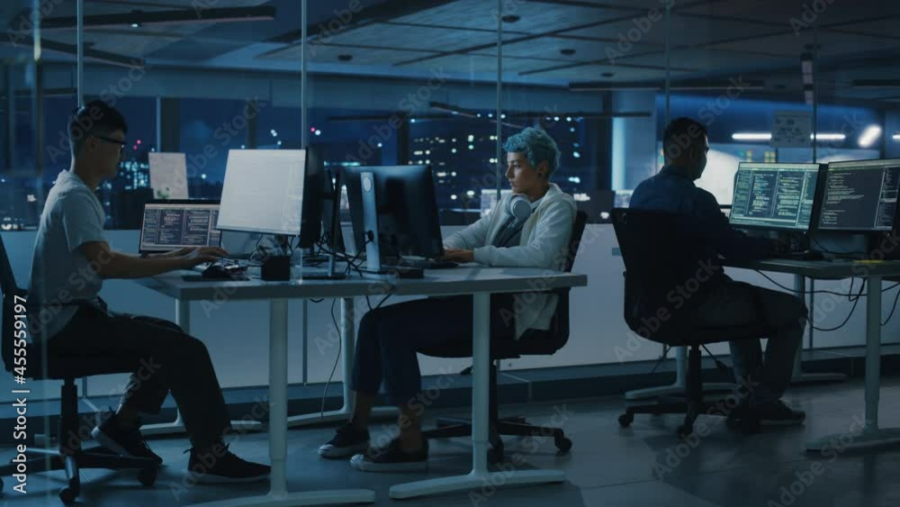Poster Diverse Office at Night: Multi-Ethnic Team of Young Programmers Working on Computers, Screens Show Coding Language User Interface. Software Engineers Create Innovative e-Commerce App. Wide Dolly