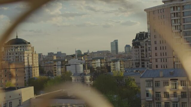 A cinematic shot of the city in the rays of the setting sun.
