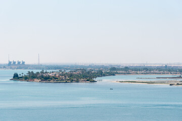 Bank of the Suez Canal, panorama view from transiting cargo ship. 