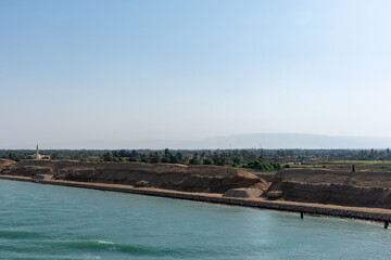 Bank of the Suez Canal, panorama view from transiting cargo ship. 