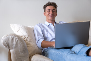 Smart working with laptop computer on sofa at home  - young people with  technology - modern lifestyle with remote work stock photo