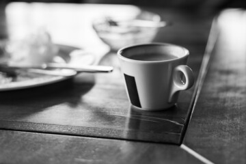 Bowl of fragrant coffee on a table in a cafe. Morning in the city. Nice breakfast.