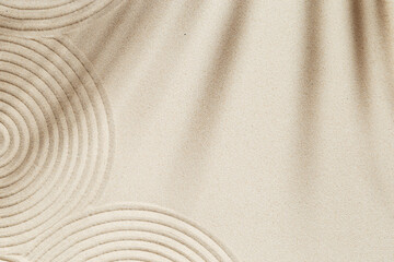 Zen garden meditation sandy background for relaxation. Lines drawing in sand and shadows of palm...