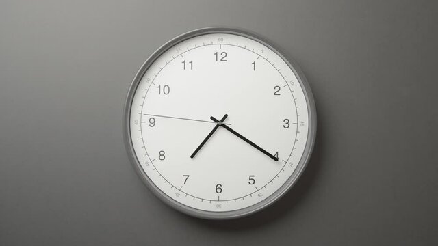 Clock Face on Dark Grey Office Wall in Timelapse
