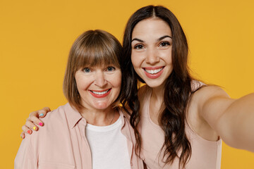 Close up two young smiling happy daughter mother together couple women wearing casual beige clothes...