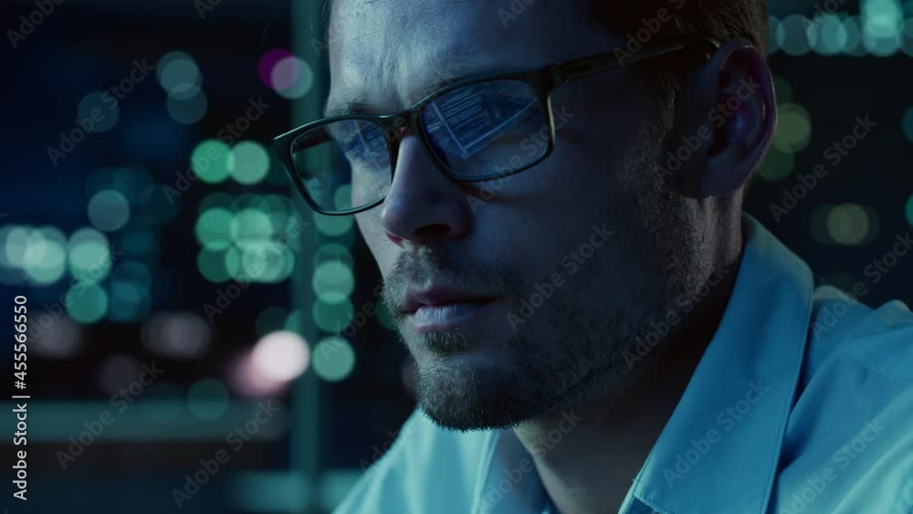Poster At Night Portrait of Handsome Startup Digital Entrepreneur Working on Computer, Line of Code Reflecting in Glasses. Developer Working on Innovative e-Commerce App using AI Algorithm to use Big Data.