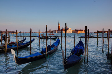 Fototapeta na wymiar Gondolas in St. Mark's square with Saint George's island at sunrise, Venice, Italy