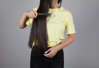 Woman combing her hair. Beautiful hair concept.