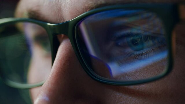 Super Close-up Portrait of Software Engineer Working on Computer, App Reflecting in Glasses. Digital Developer Working on Innovative e-Commerce Application with Machine Learning, AI, Big Data
