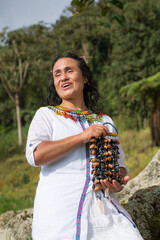 Portrait of a woman from the Colombian indigenous community, with a musical instrument in her...