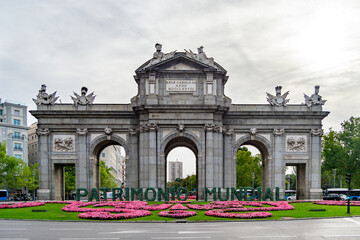 Fototapeta na wymiar MADRID, SPAIN - SEPTEMBER 7, 2021. Puerta de Alcalá, located in the center of the roundabout of the Plaza de la Independencia, next to the Retiro Park. World Heritage architecture, in Spain. Europe.