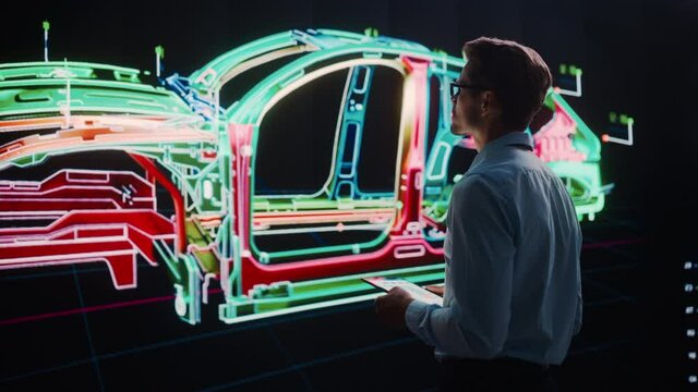 Innovative Green Energy Startup: Engineer Designing Electric Car Using Tablet Computer and Big Wall Screen to Analyse Prototype. Concept for Sustainable Environmnetally Friendly Zero Emissions Vehicle