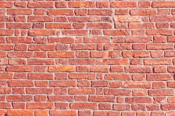 A brick wall in an old house. The texture of aged brickwork.